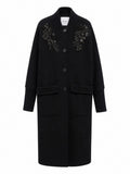 Manteau noir à broderies perlées et col côtelé