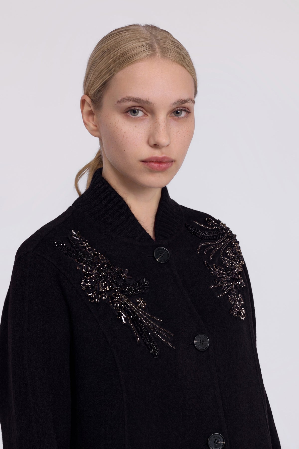 Manteau noir à broderies bijou et col côtelé