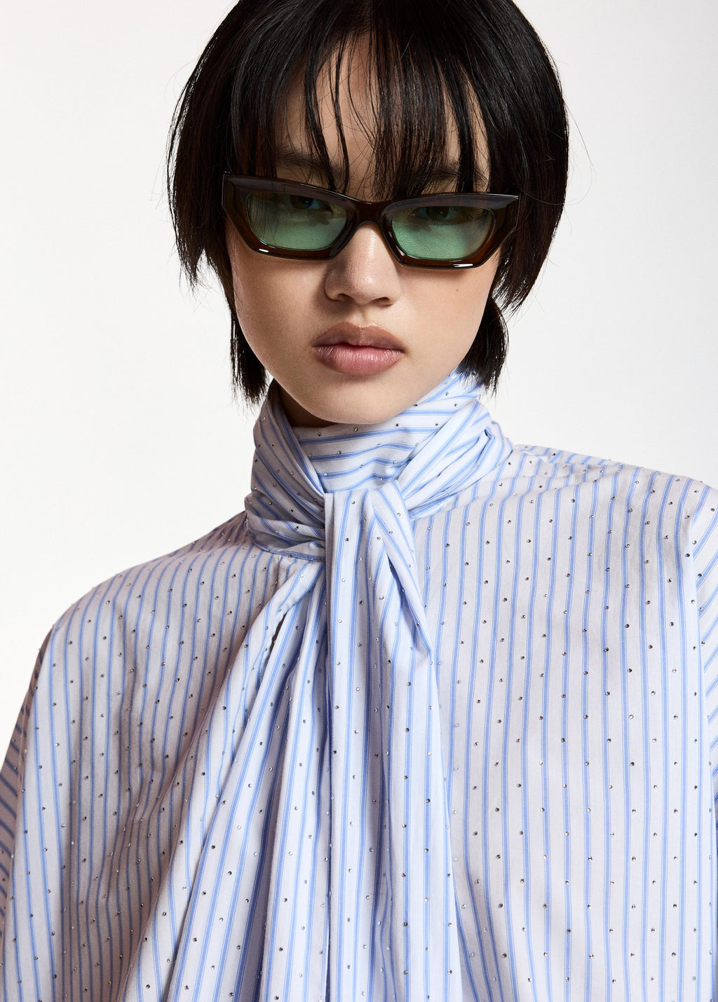 Pussy-bow top with trumpet sleeves and light blue and white stripes