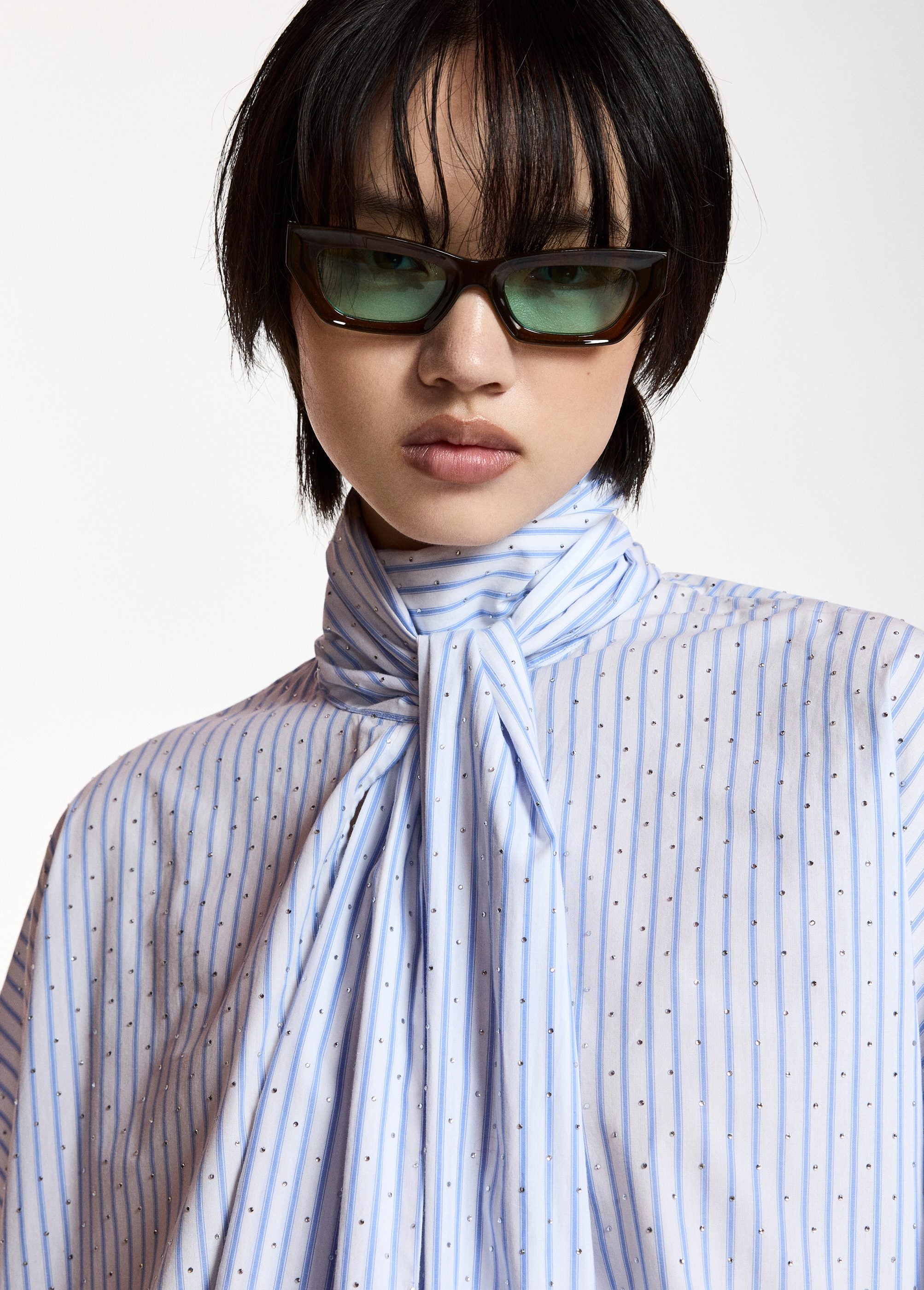 Pussy-bow top with trumpet sleeves and light blue and white stripes
