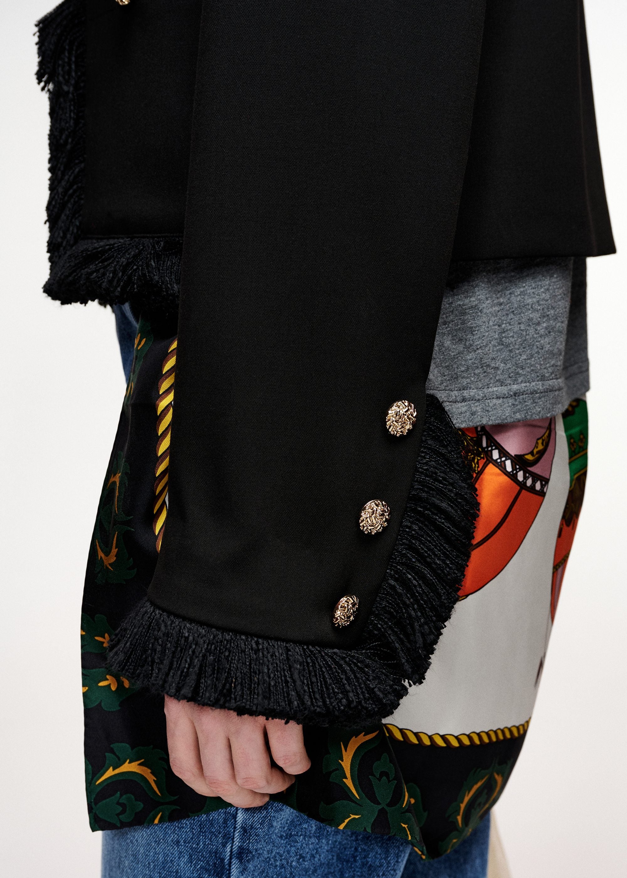 Black fitted jacket with fringed details and patch pockets