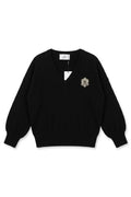 Black Perle sweater with jewelry on the pocket